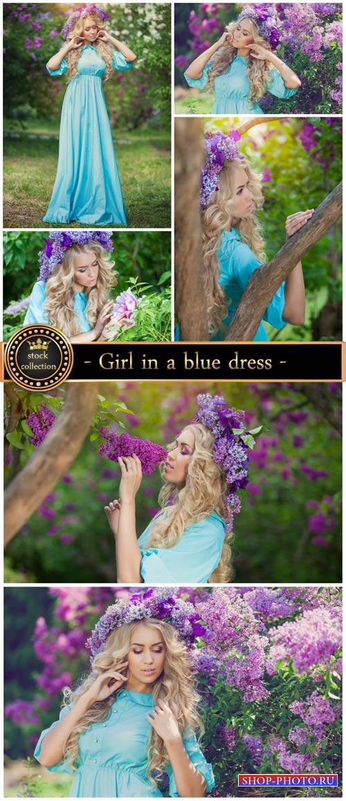 Girl in a blue dress, lilac bushes - stock photos
