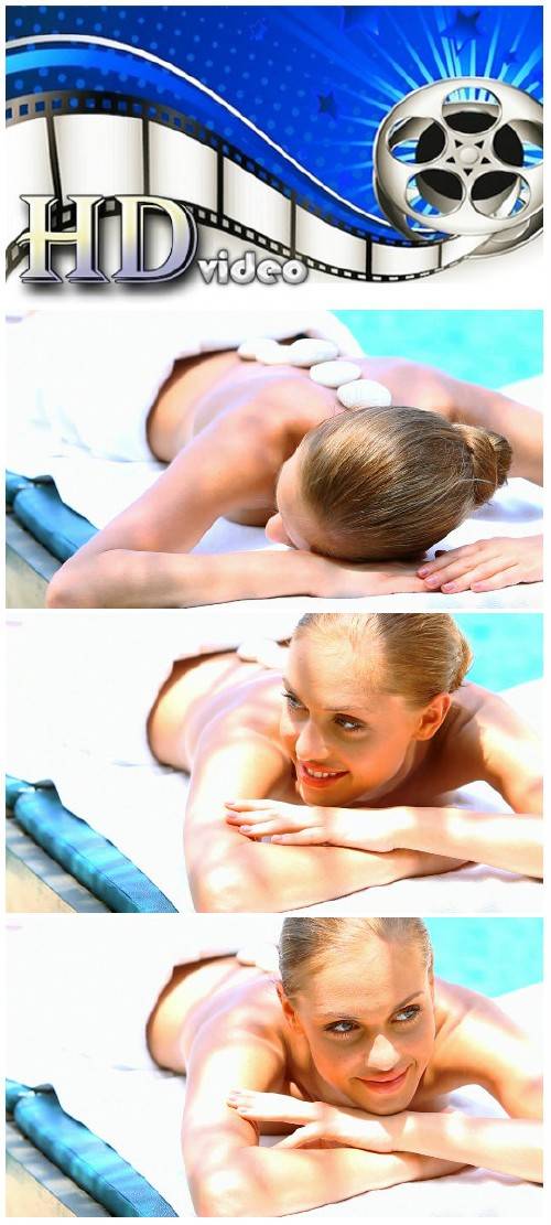 Video footage Woman taking hot stones massage in tropical outdoor